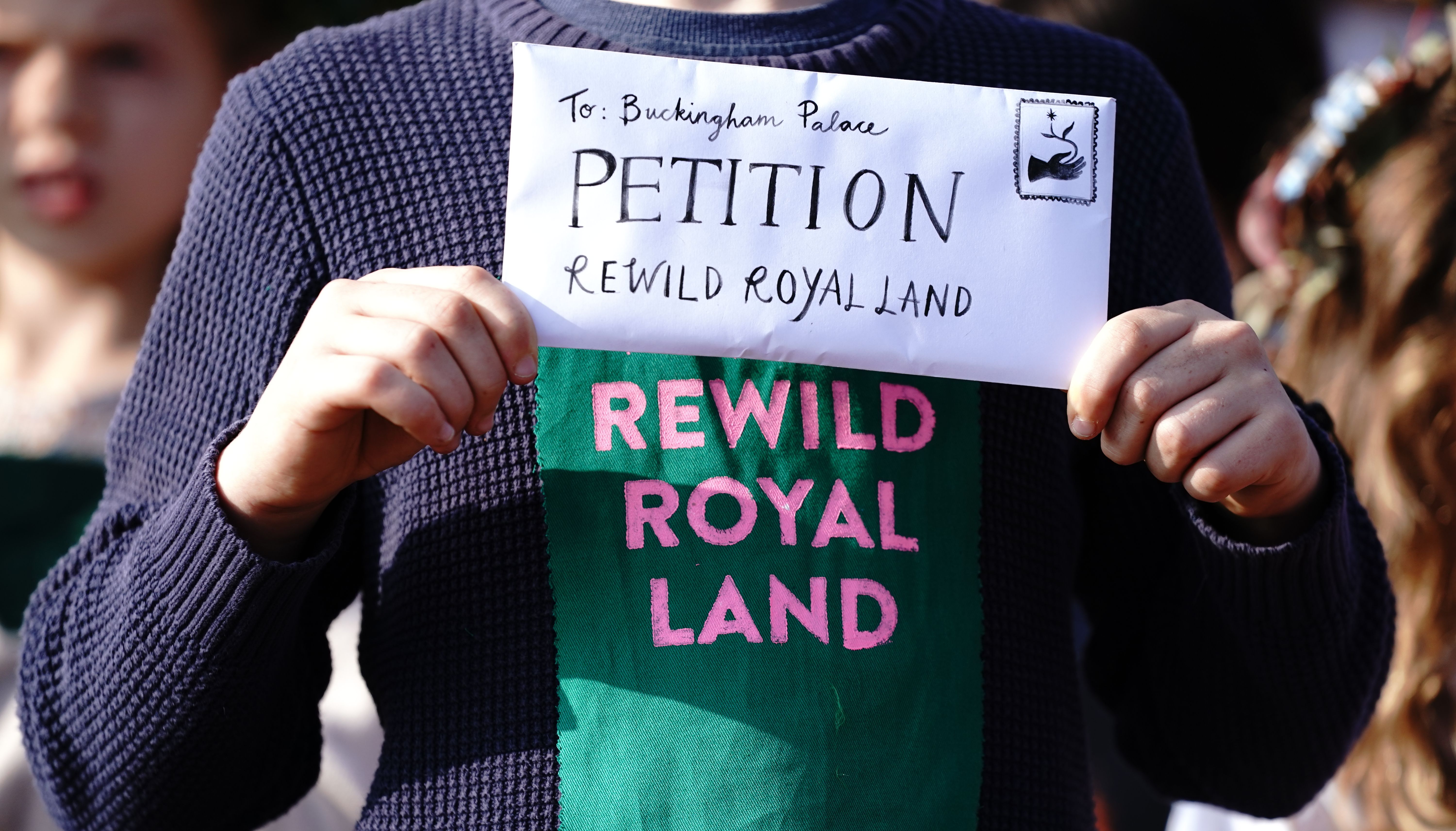 14 year old Simeon Macaulay delivers a Wild Card campaign petition signed by 100,000, to Buckingham Palace, London, calling on the royal family to re-wild their estates.
