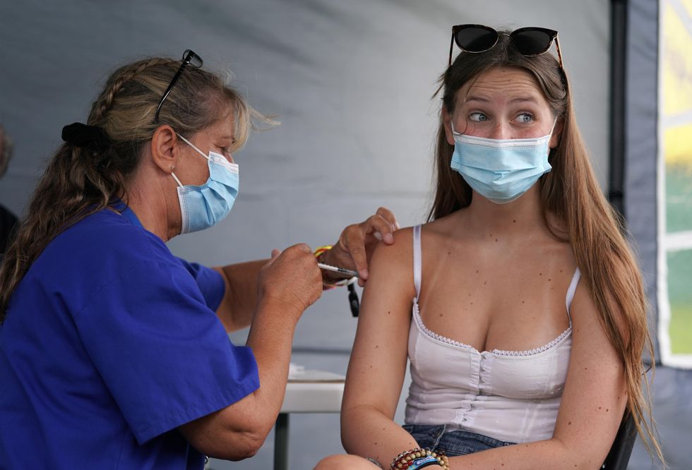 16 year old festival goer Lottie Beard getting a vaccine jab at a walk-in Covid-19 vaccination clinic at the Reading Festival at Richfield Avenue. Picture date: Thursday August 26, 2021.