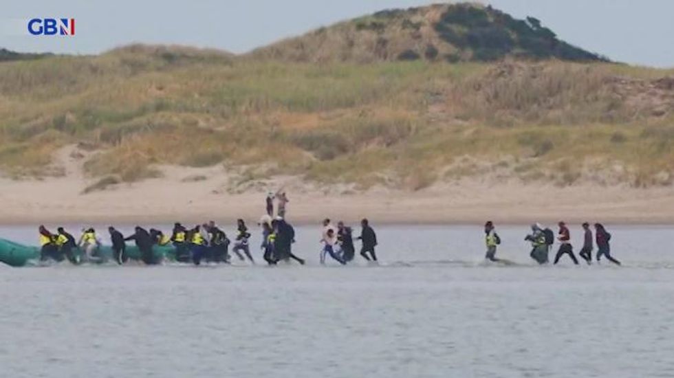 Migrants filmed clambering onboard inflatable to cross the Channel in exclusive GB News drone footage