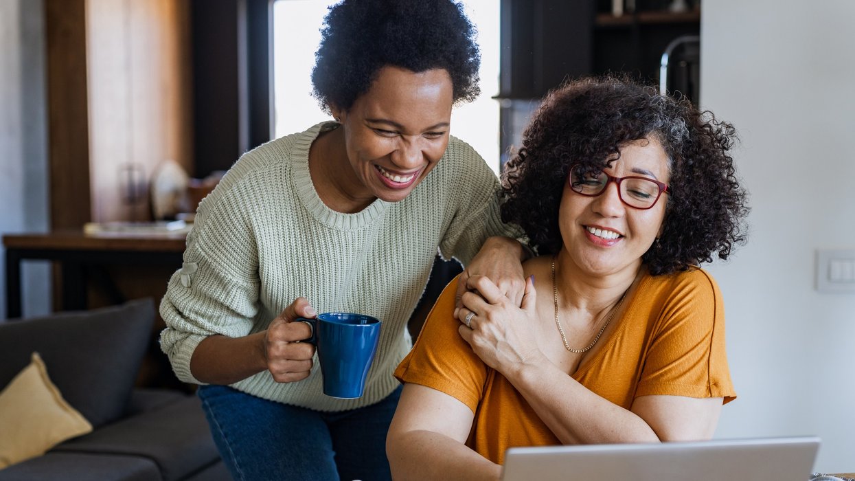 2 women looking at laptop smiling