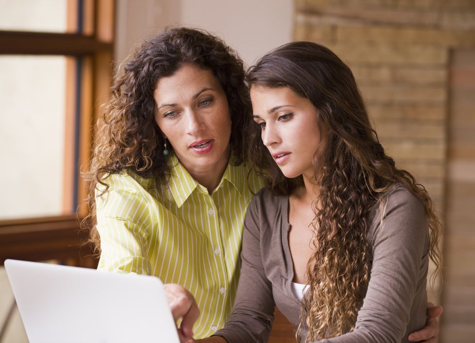 2 women reading on a laptopo