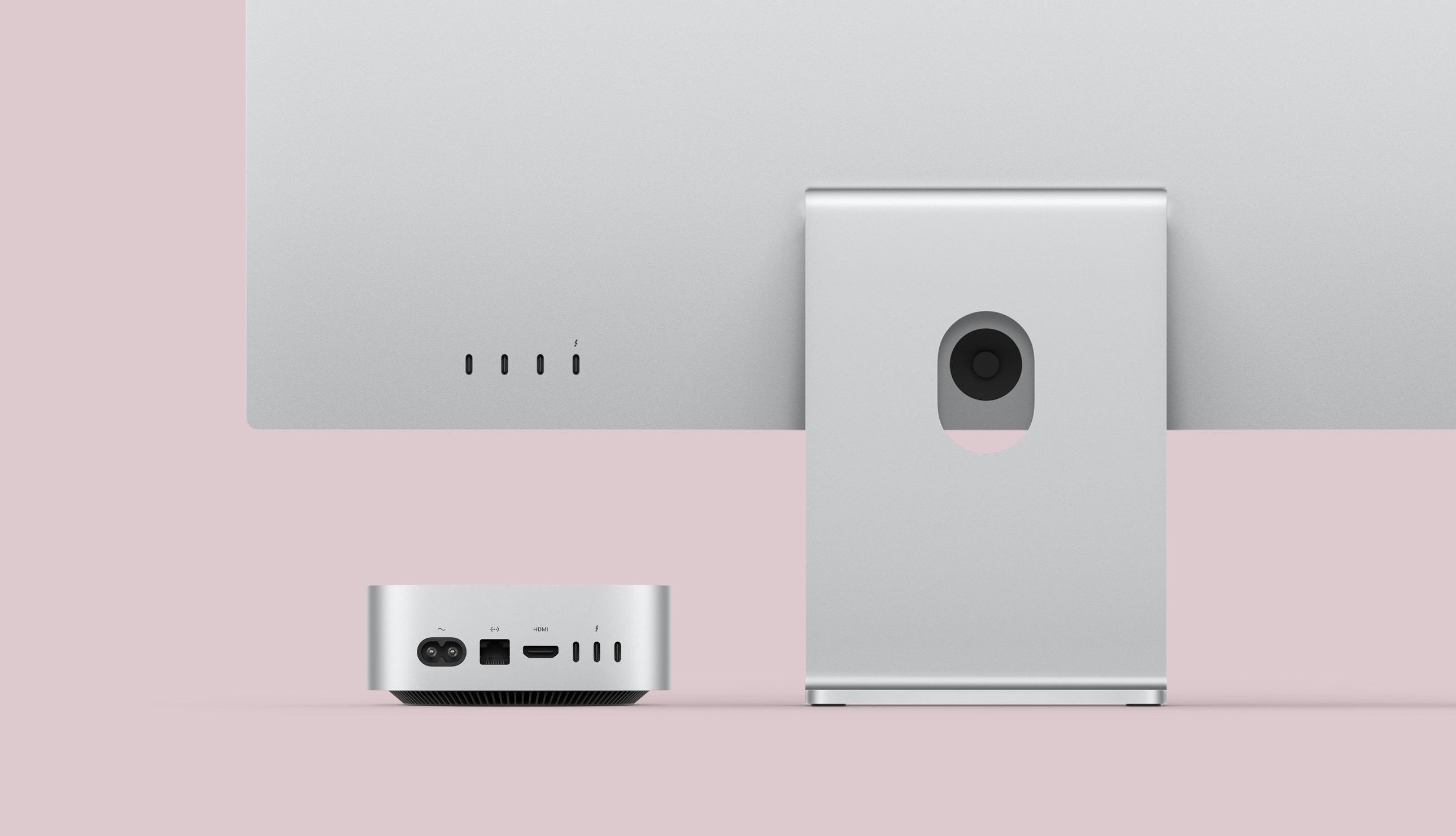 2024 mac mini pictured from the back beside an apple pro display xdr