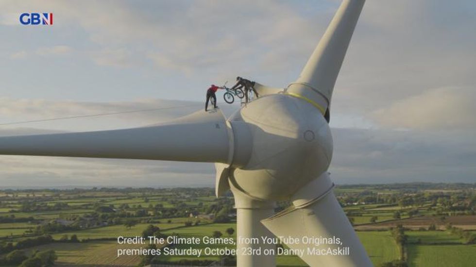 Cop26: Pro-cyclist performs stunt on wind turbine to raise awareness of climate change