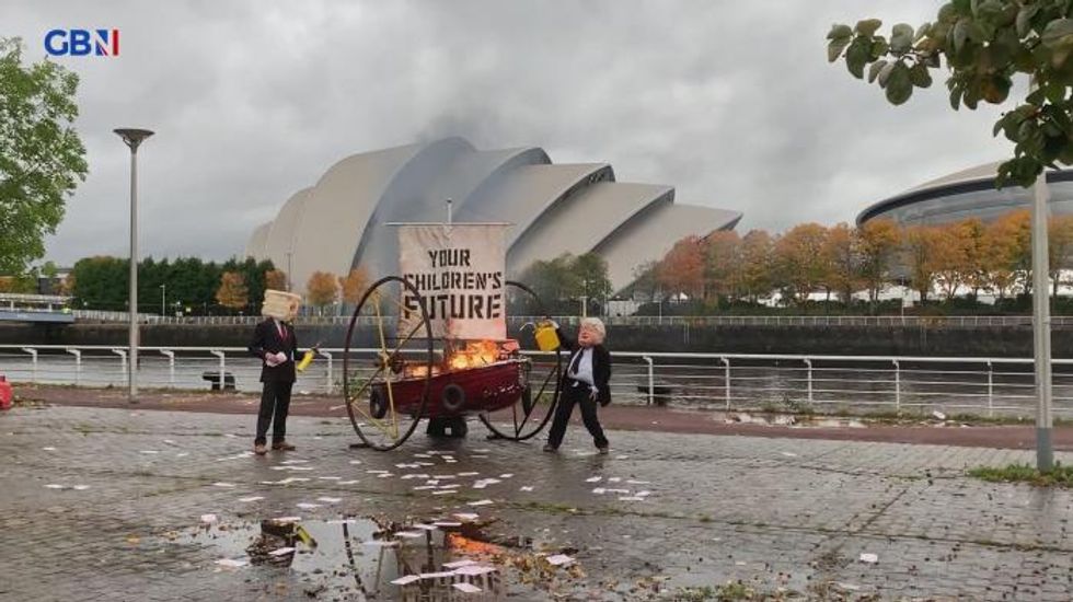 Cop 26: Climate protester dressed as Boris Johnson sets fire to prop boat