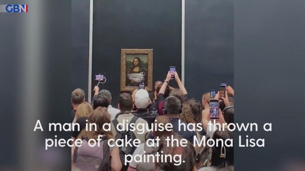 Man dressed as woman in wheelchair hurls cake at Mona Lisa painting
