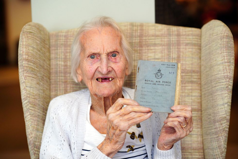 99-year-old WAAF veteran, Mrs Margaret 'Peggy' Terry, holds her RAF service record document after she is presented five wartime silver shillings and a framed picture by Air Specialist Class 1 William Anderson at Gwernllwyn Care Home, Gorslas, Wales, as a gesture of appreciation for her service when, during a recent conversation, she jokingly mentioned to AS1 Anderson she was still owed five shillings after leaving the RAF, back in 1945. Picture date: Monday August 22, 2022.