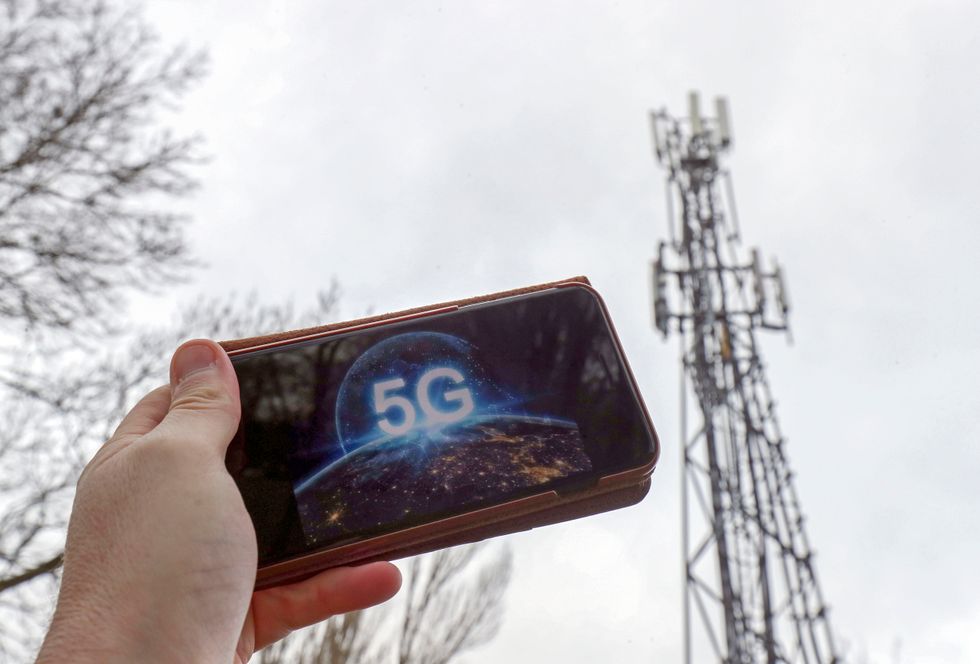A 5G phone next to a telecoms mast near Wokingham, Berkshire. Britain's sovereignty is at risk if the country allows Chinese tech giant Huawei to help build its 5G infrastructure, the US Secretary of State has warned.