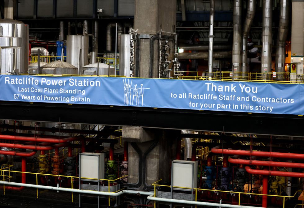 A banner hangs in the offline turbine hall of Ratcliffe on Soar Coal-fired power station in Nottinghamshire
