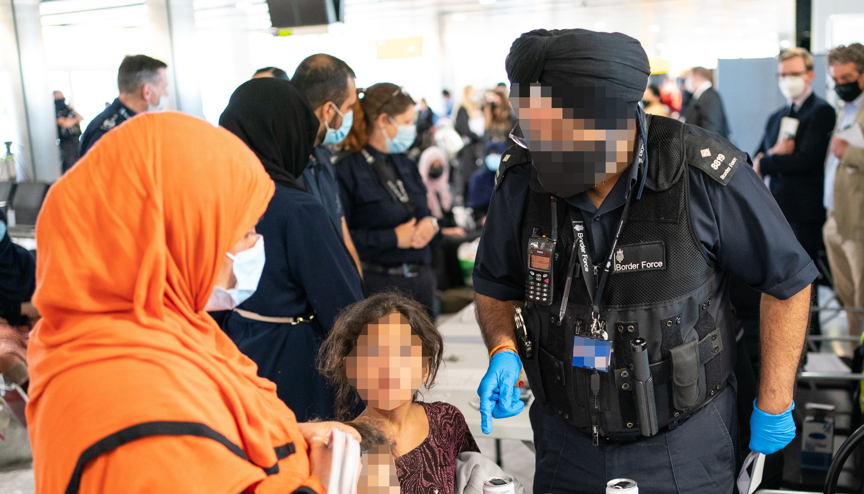 A Border Force worker processes refugees from Afghanistan who arrived on an evacuation flight at Heathrow Airport in August, 2021