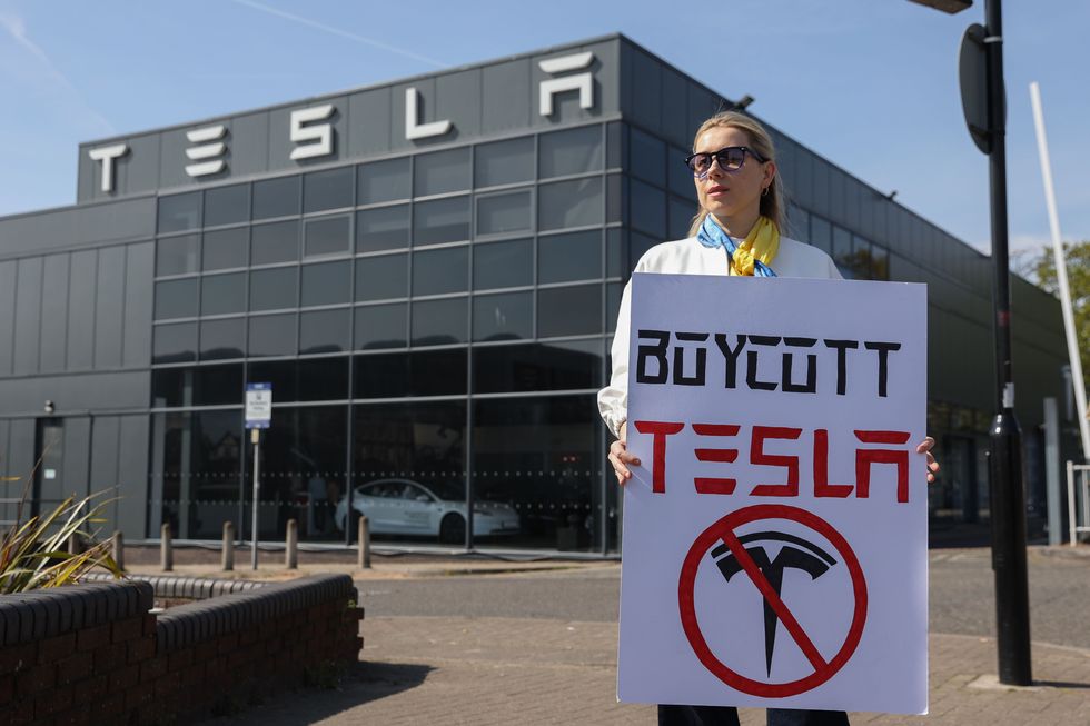A 'Boycott Tesla' sign in front of a Park Royal, London, store