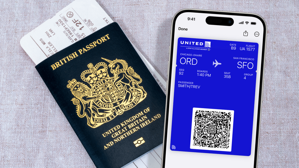 a british passport with a printed boarding pass pictured in the background, with the wallet app showing a boarding pass in the foreground