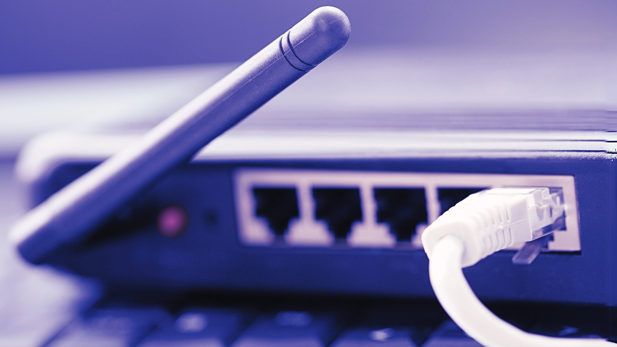 a broadband wifi router with an ethernet cable plugged into the back