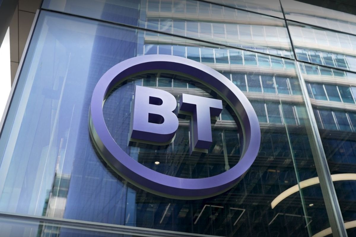 a bt logo is pictured on the side of a glass high-rise building 