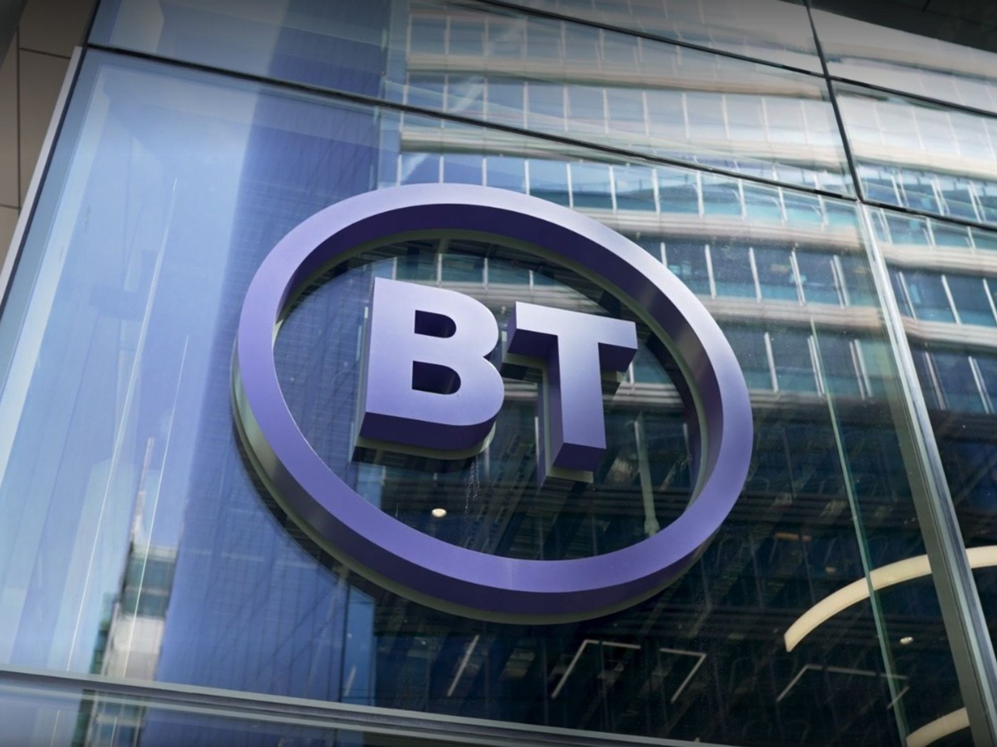 a bt logo is pictured on the side of a glass high-rise building