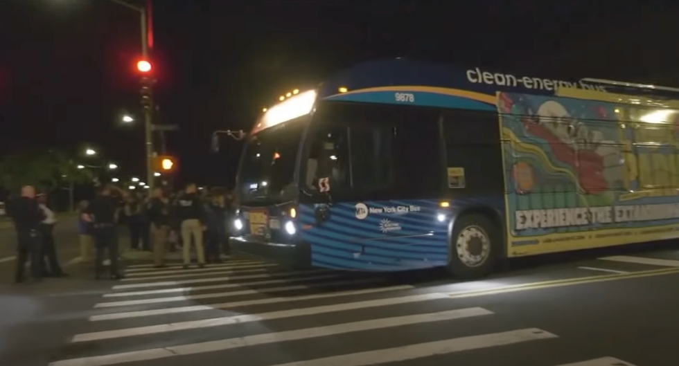 A bus carries migrants through Staten Island in New York