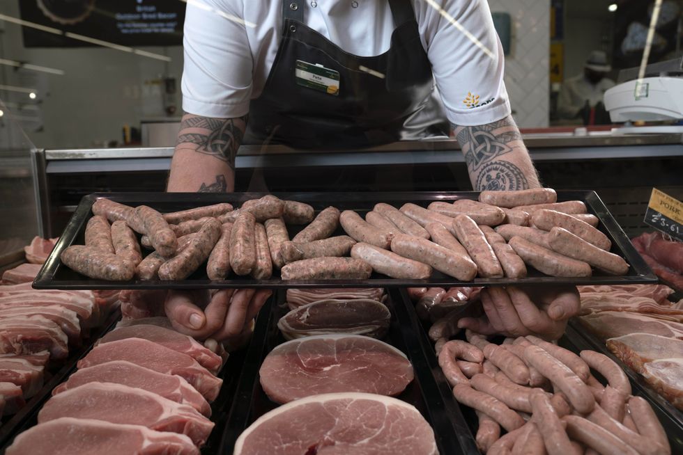A butcher presents his product
