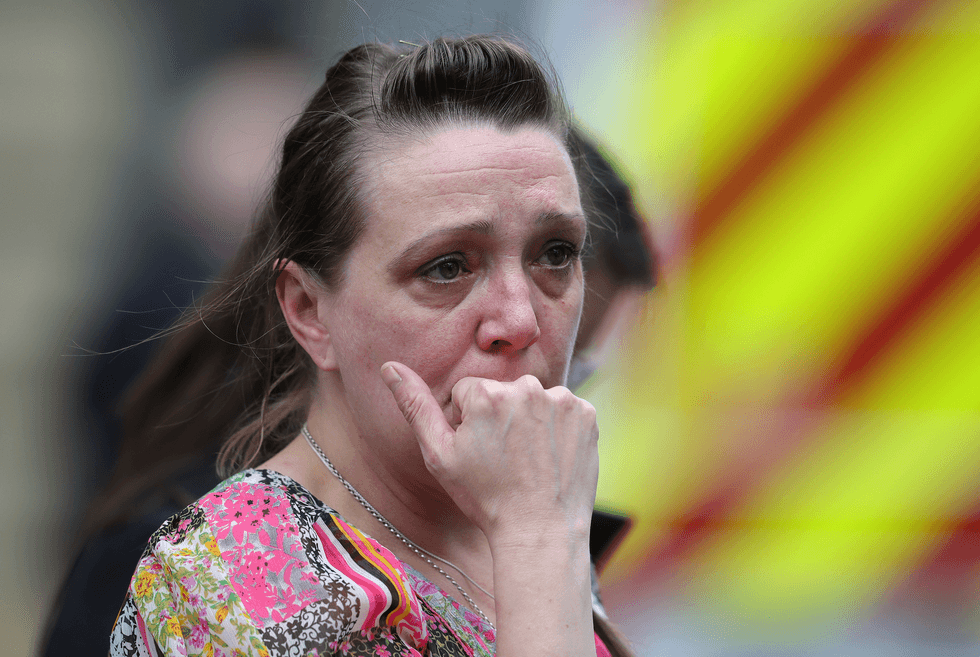 A bystander looking visibly shocked in the aftermath of the Manchester Arena bombing