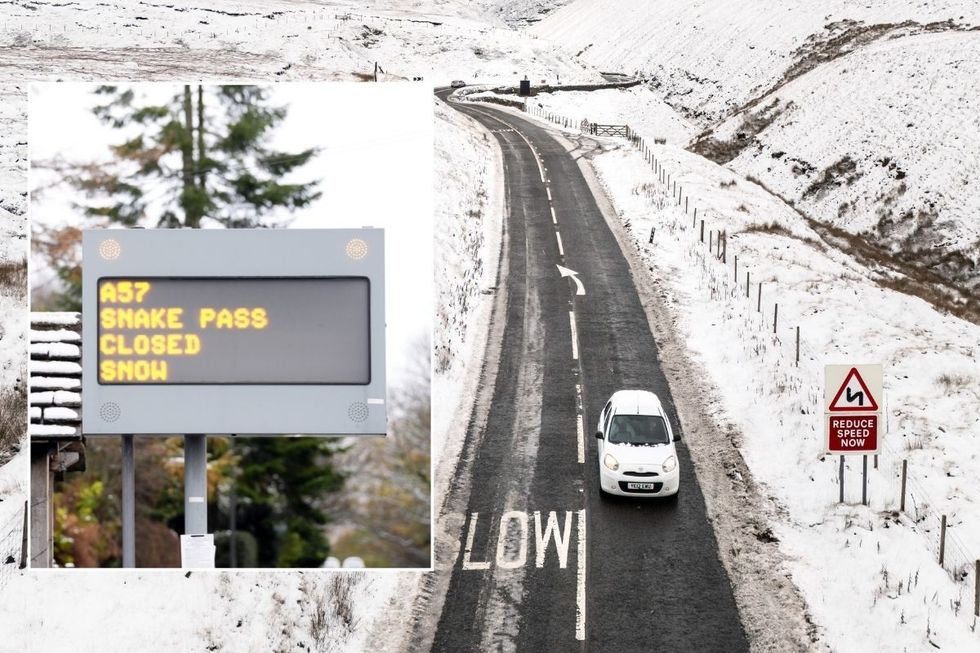 A car driving along thee A57 Snake Pass in Derbyshire in the snow and a Snake Pass closed sign