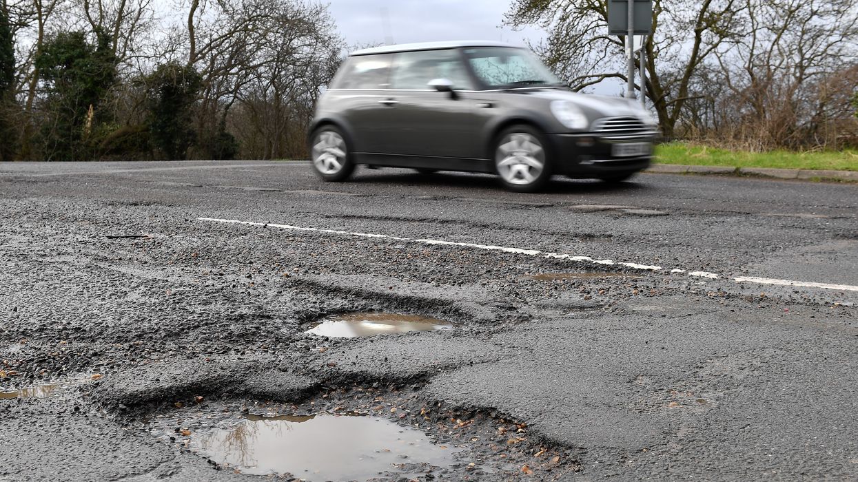 A car driving near a pothole