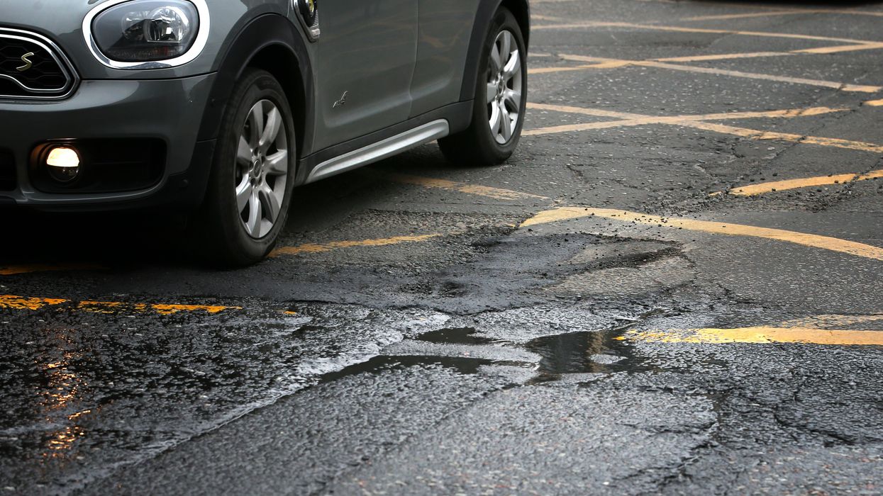 A car driving over a pothole