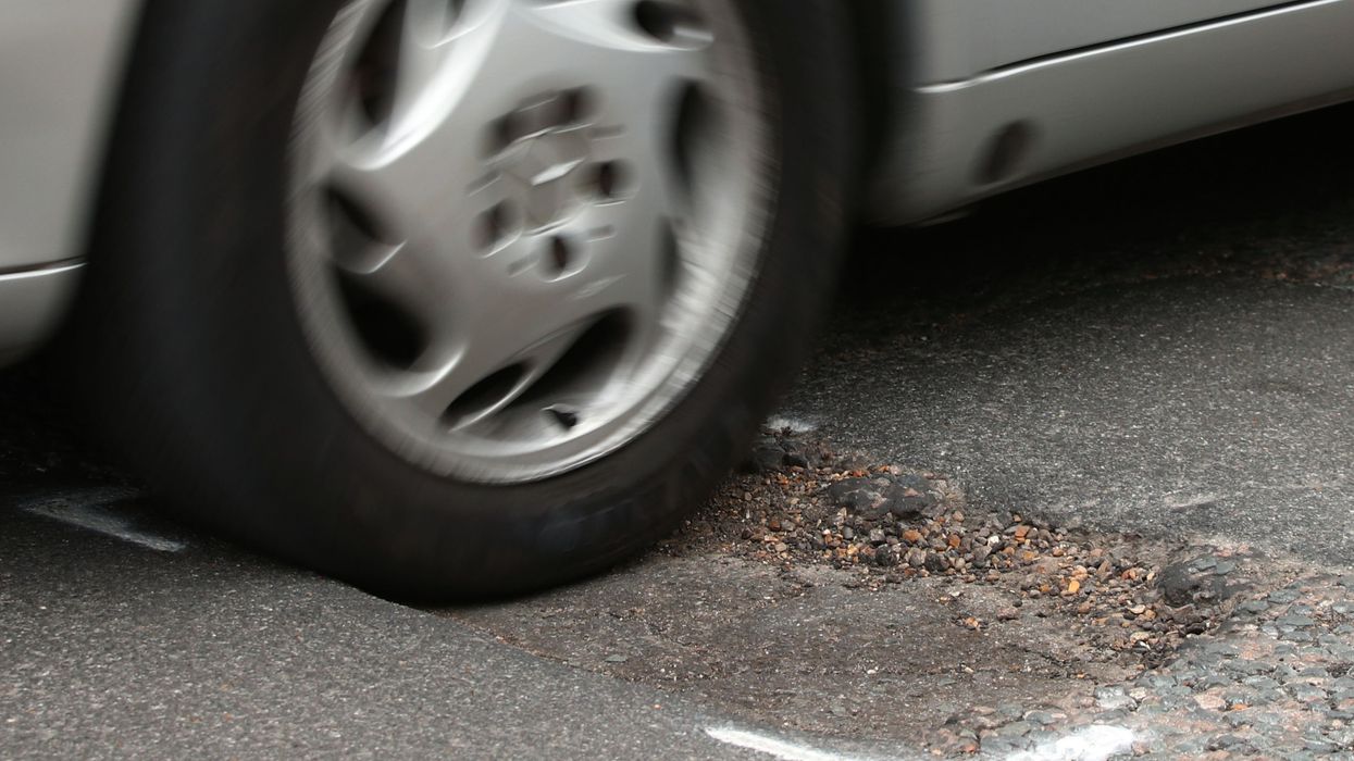 A car driving over a pothole
