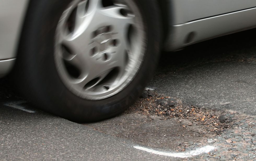 A car driving over a pothole