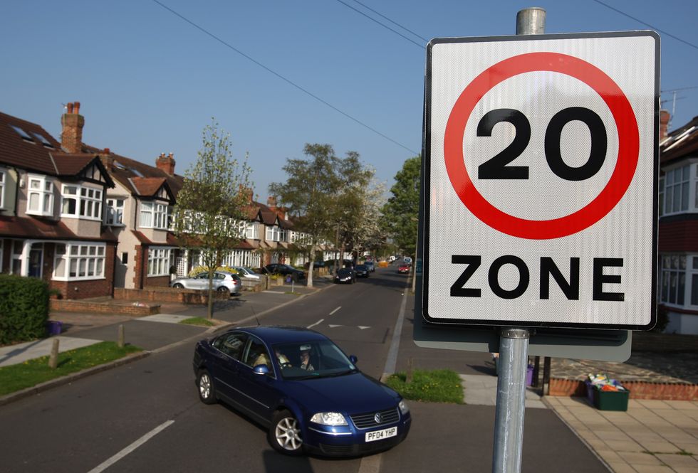 A car driving past a 20mph speed limit sign
