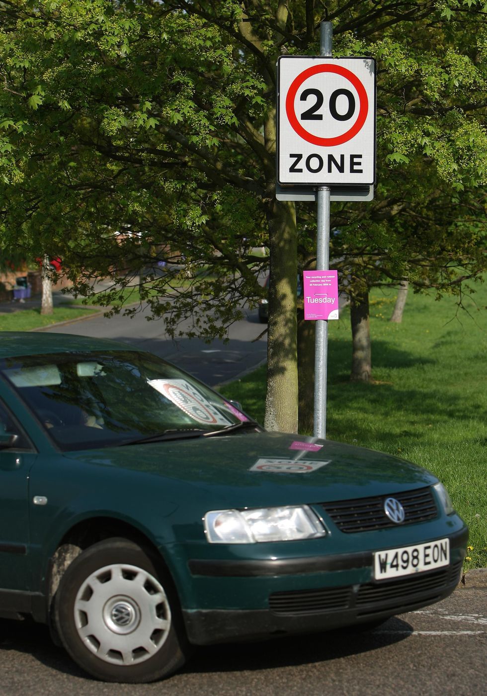 A car driving past a 20mph speed limit sign