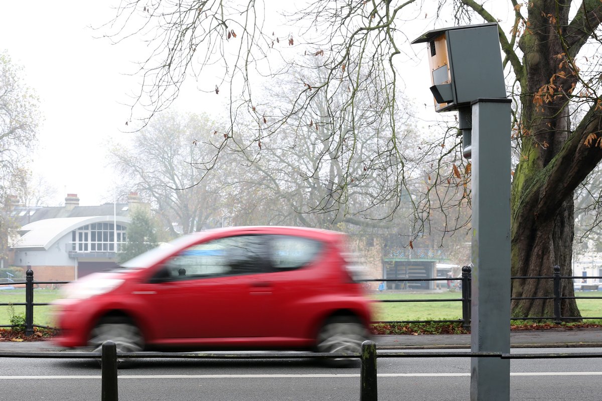 A car driving past a speed camera