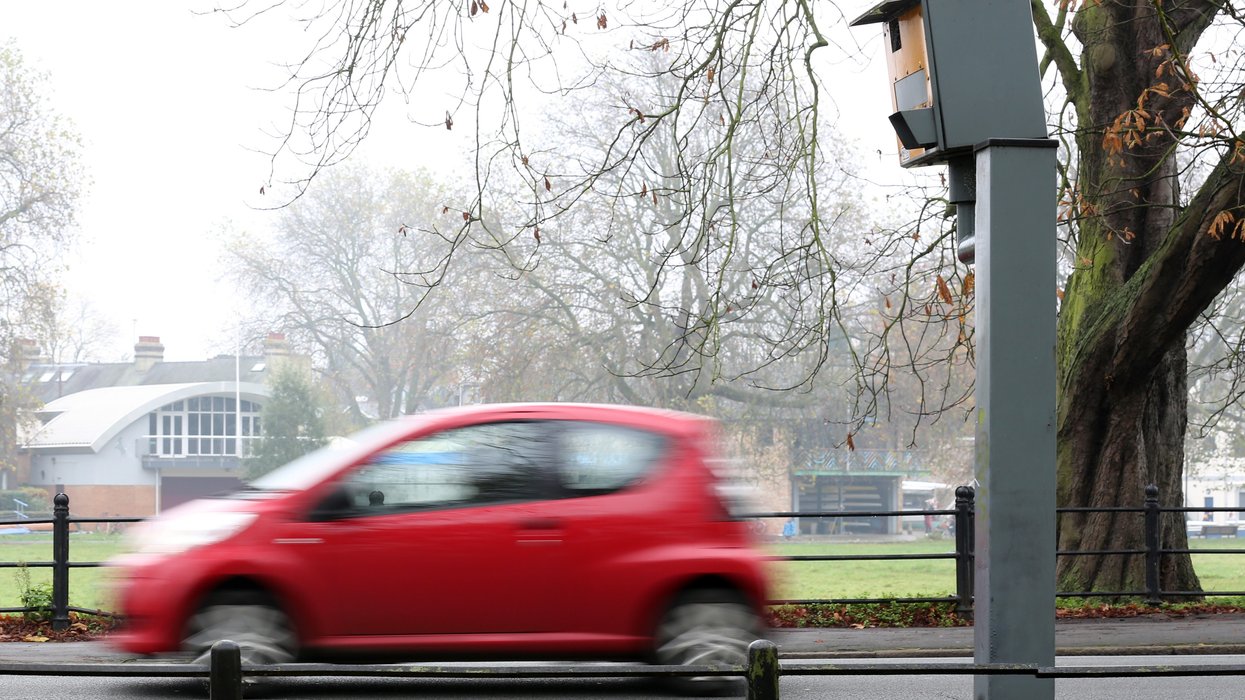 A car driving past a speed camera