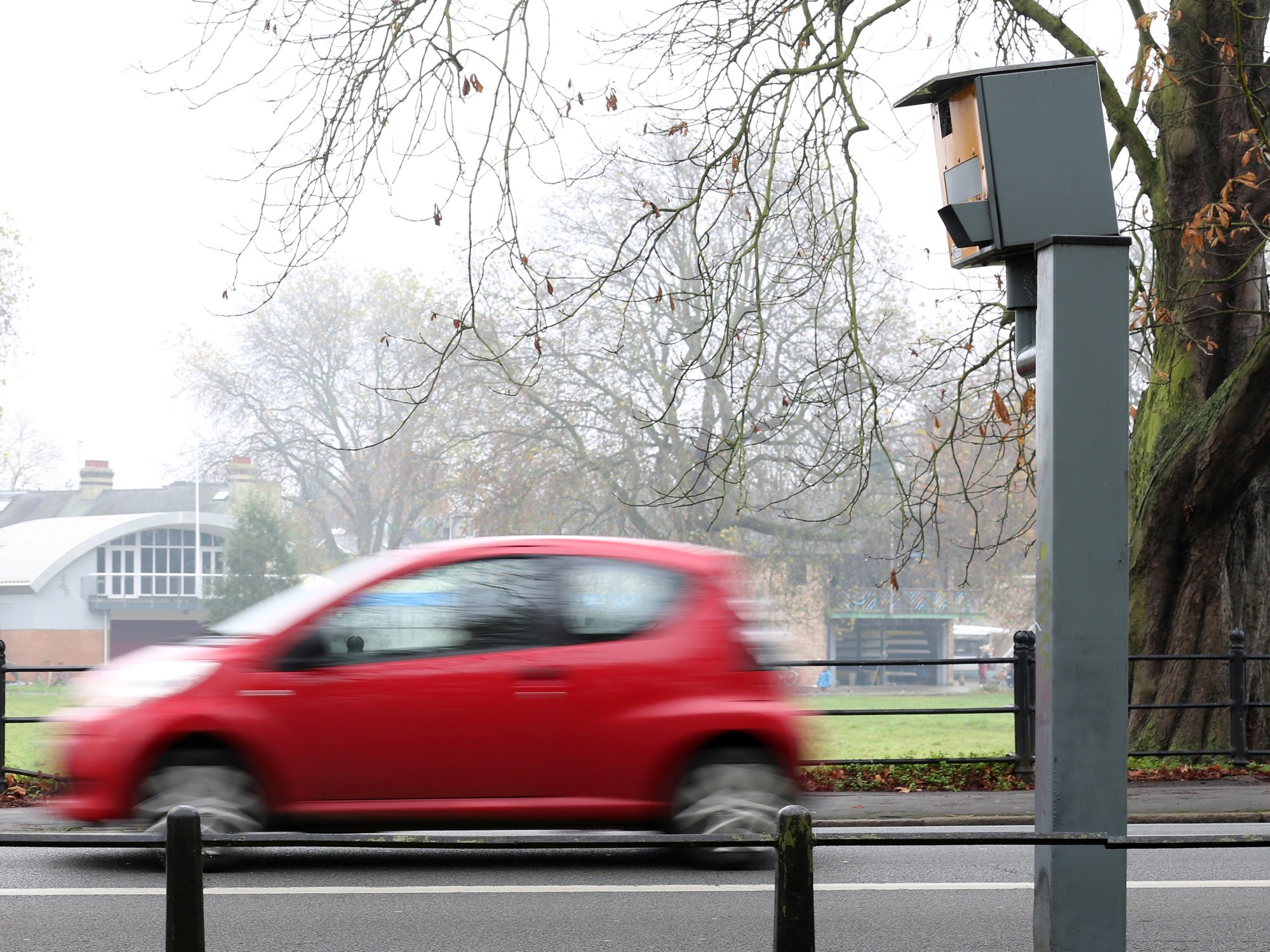 A car driving past a speed camera