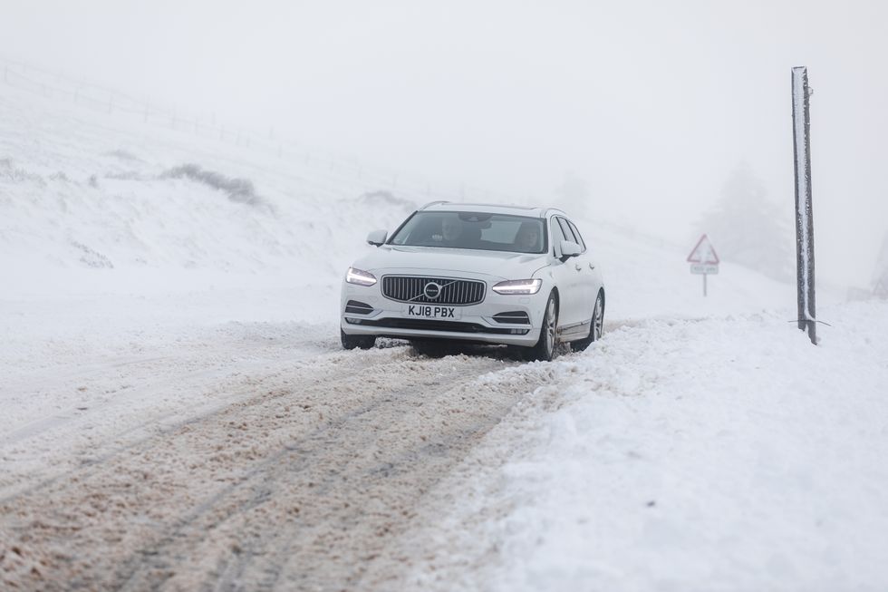 A car makes it way along the A939 after heavy snowfall in the Cairngorms, Scottish Highlands. Wintry showers are expected to create icy conditions across all four nations of the UK from Sunday evening, forecasters have warned. The Met Office has issued a yellow warning for ice covering Northern Ireland, southern Scotland, northern England, northern Wales and the Midlands, while hundreds of flood warnings are in place across the UK. Picture date: Sunday January 15, 2023.
