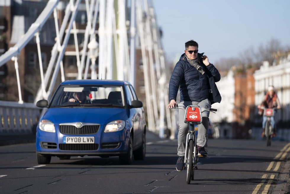 A car overtaking a cyclist