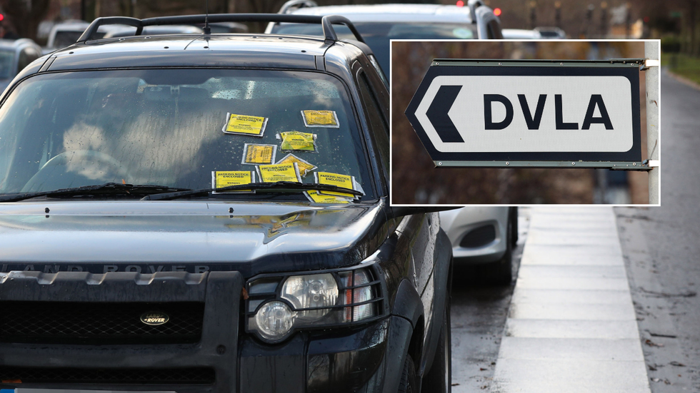 A car with parking tickets and a DVLA sign