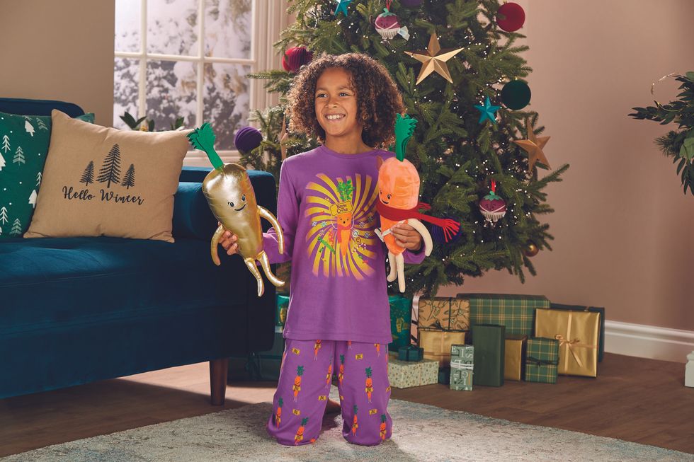 A child holding Kevin the Carrot