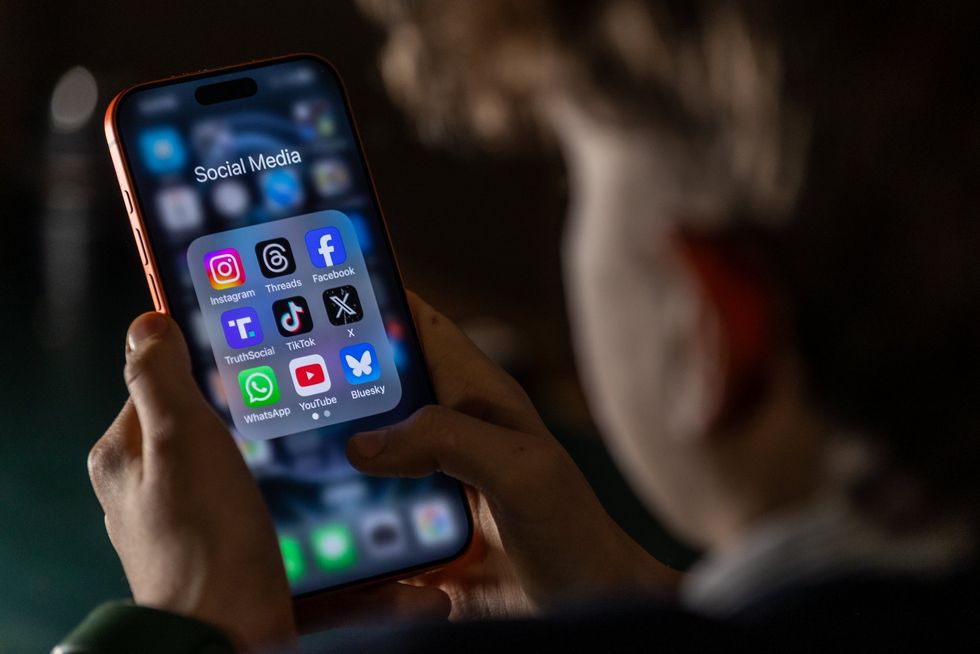 A child is seen looking at social media apps
