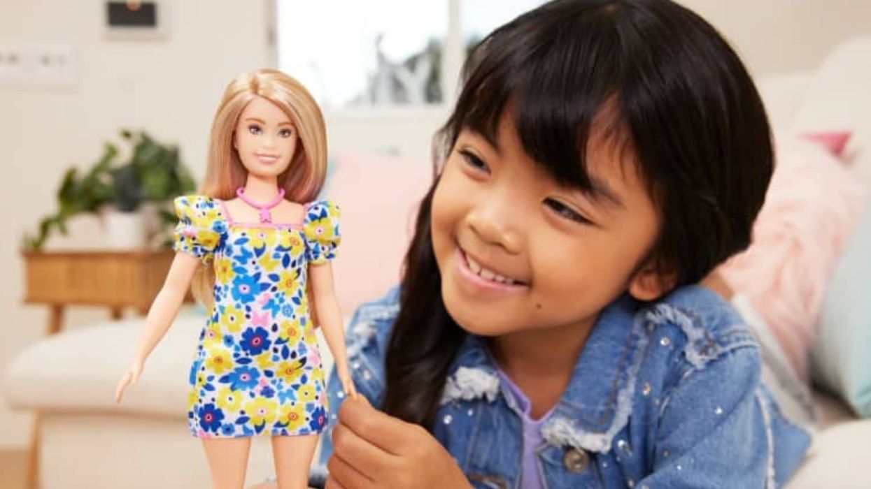 A child playing with a Barbie