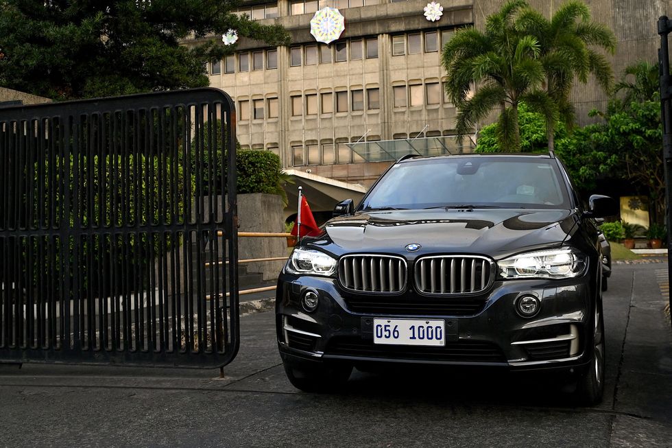 A Chinese diplomatic vehicle leaves the Department of Foreign Affairs in Manila on December 11, 2023