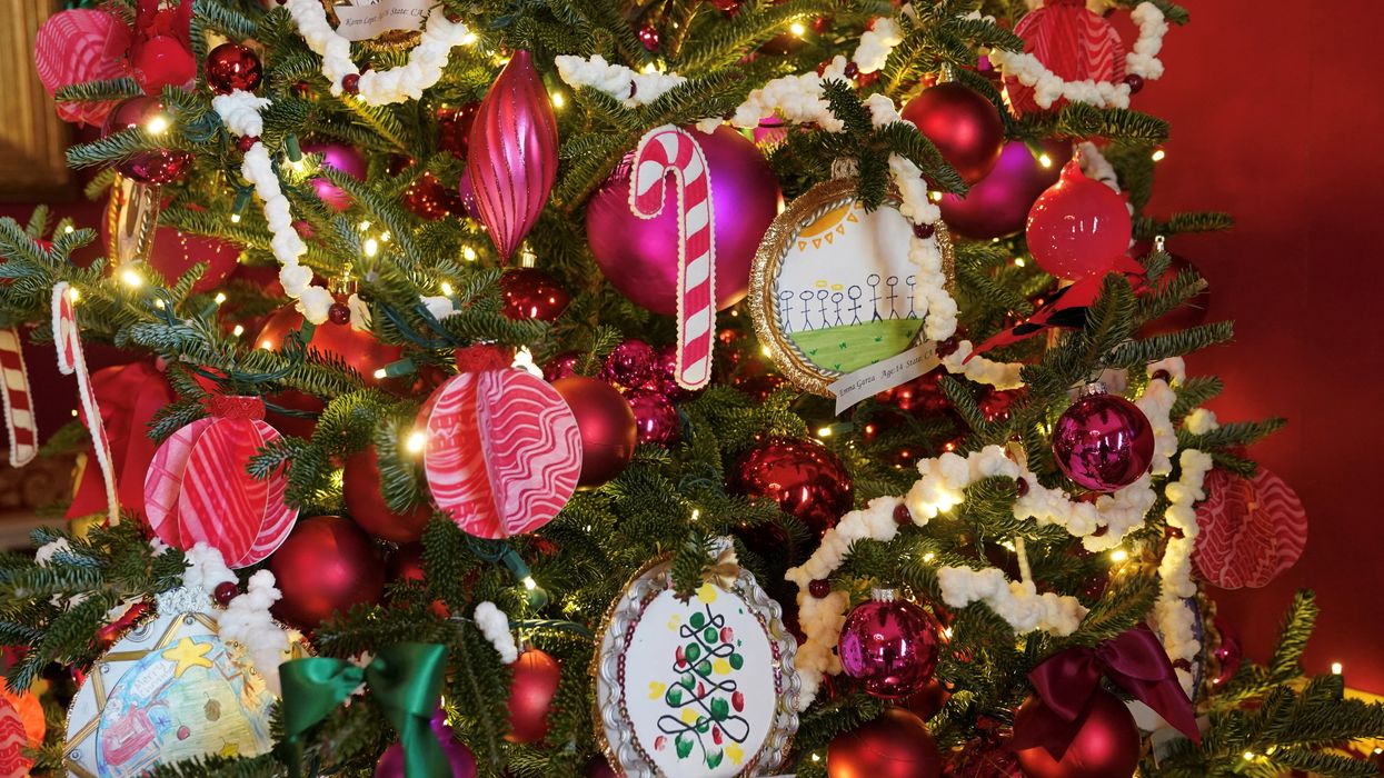 a christmas tree with tinsel, baubles and lights