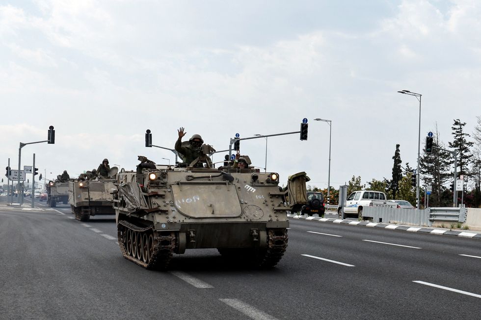 A convoy Armoured Personnel Carriers (APCs) makes their way to Israel's border with Lebanon