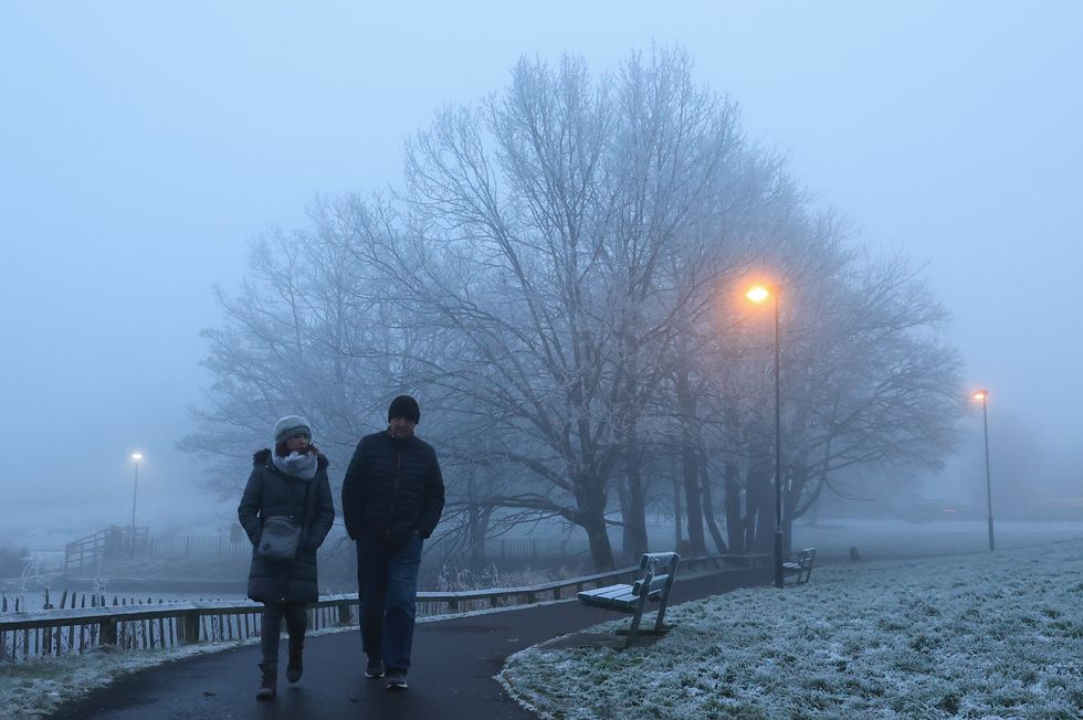 A couple walk in the mist at Dungannon Park, Northen Ireland
