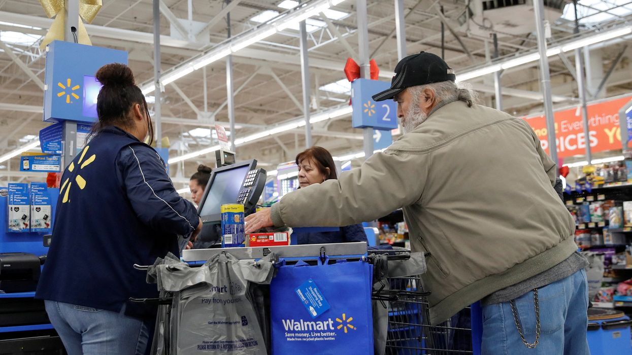 A customer bags his groceries after shopping at a Walmart store ahead of the Thanksgiving holiday in Chicago