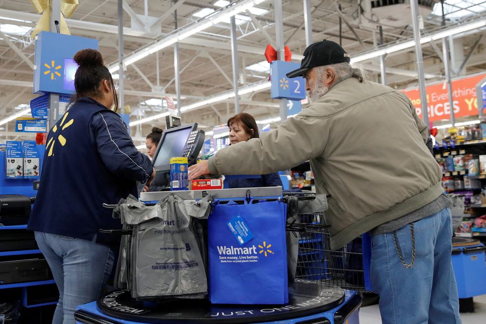 A customer bags his groceries after shopping at a Walmart store ahead of the Thanksgiving holiday in Chicago