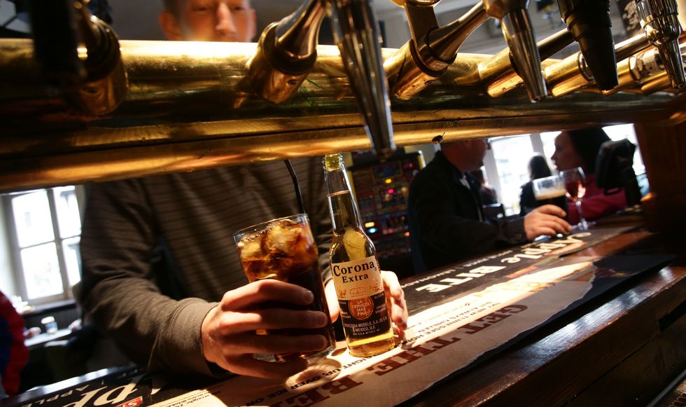 A customer collecting his drinks at the bar of Irish pub O'Neill's in Carnaby Street, central London