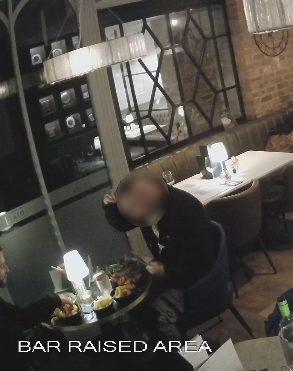 A customer was spotted appearing to pull strands of hair before placing them on his plate