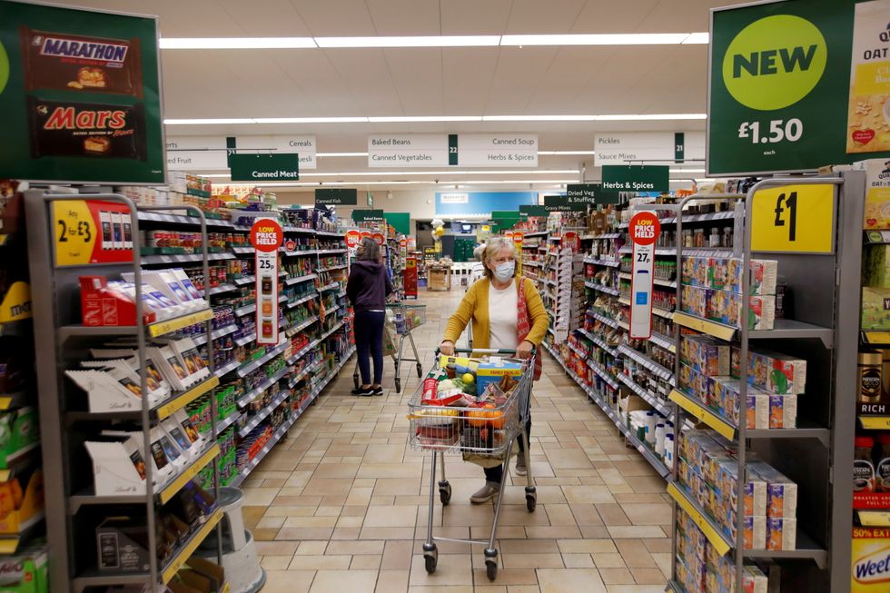 A customer wearing a protective face mask shops at a Morrisons store in St Albans