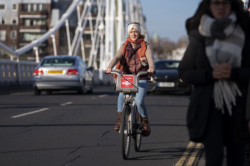 A cyclist rides their bike across Albert Bridge in Battersea, London. Picture date: Sunday January 30, 2022.