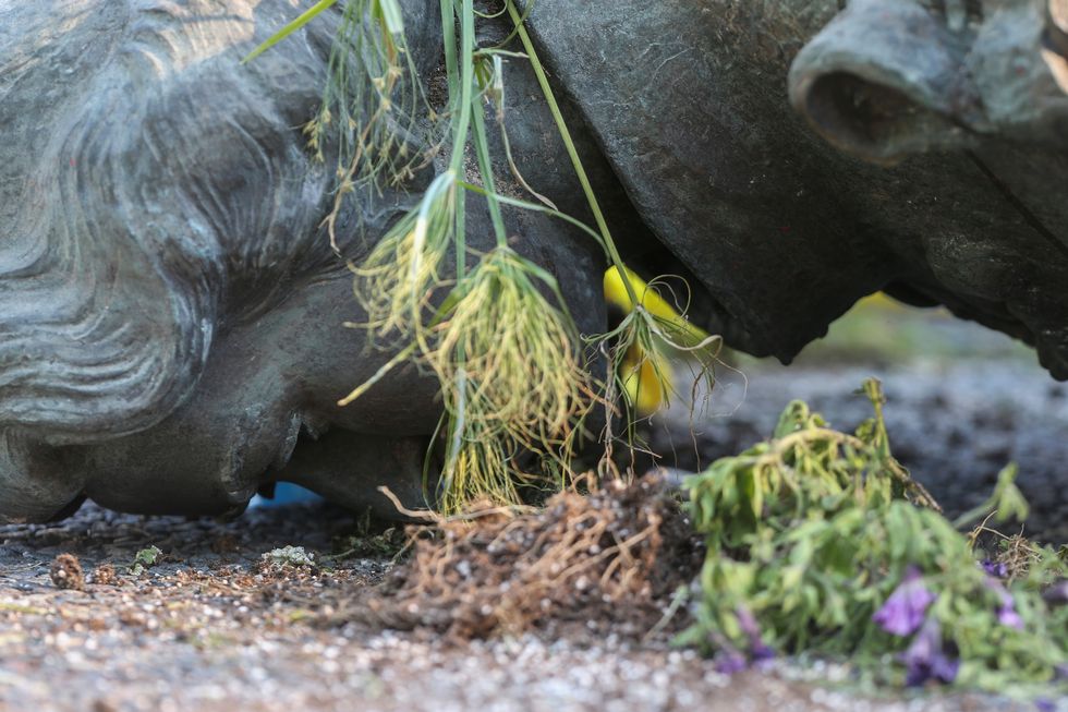 A defaced statue of Queen Elizabeth II lies after being toppled during a rally, following the discovery of the remains of hundreds of children at former indigenous residential schools, outside the provincial legislature on Canada Day in Winnipeg, Manitoba, Canada July 1, 2021. REUTERS/Shannon VanRaes