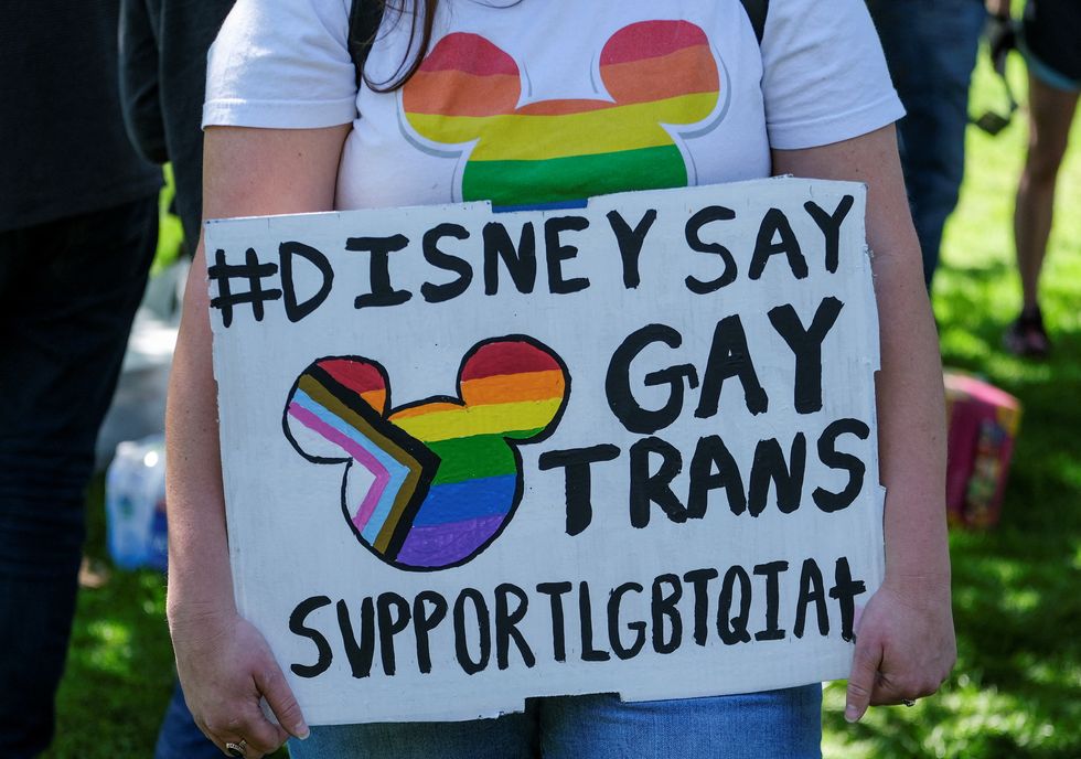 A demonstrator holding a sign takes part in a protest as Disney's employees demonstrate against Florida's %22Don't Say Gay%22 bill, in Glendale, California, U.S., March 22, 2022. REUTERS/Ringo Chiu