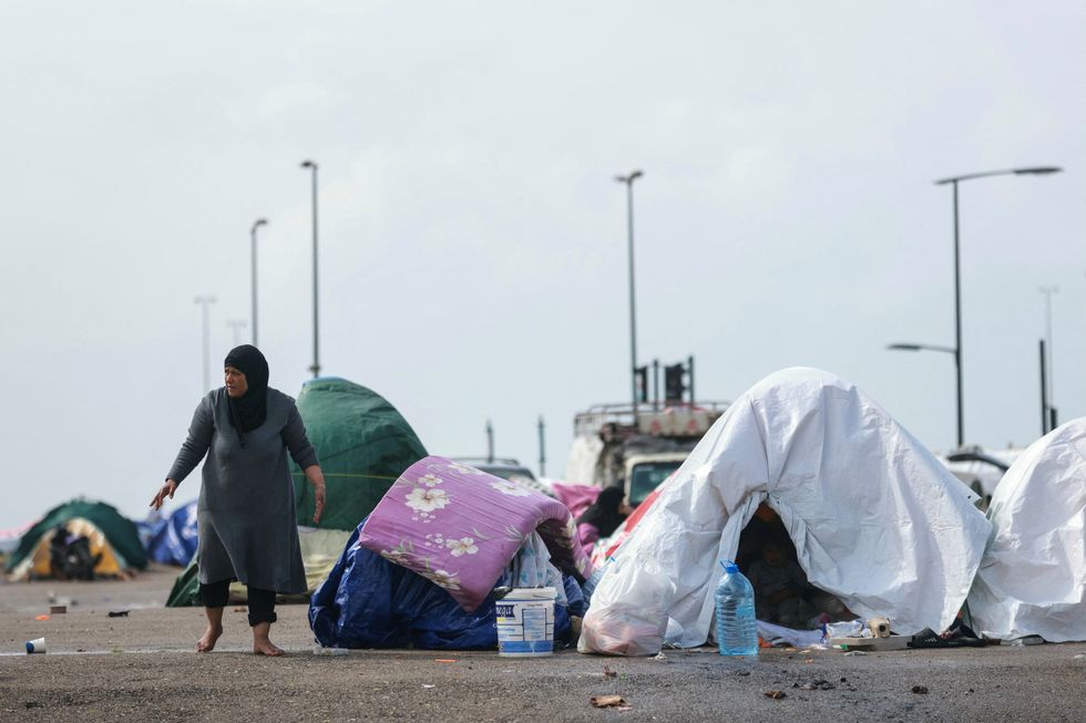 A displaced Lebanese woman on the seafront of Beirut after Israel issued evacuation orders across Lebanon